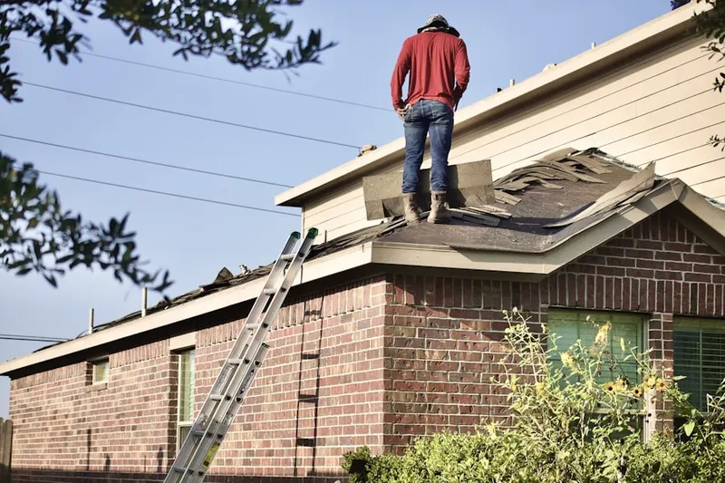 Professional roofer working on a residential roof in Hardesty Estates